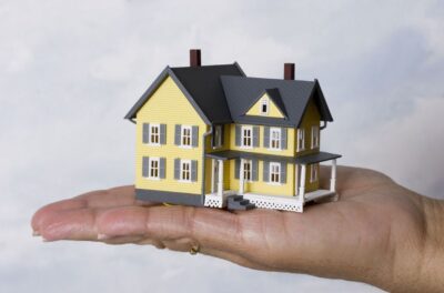 a mini model house in a hand